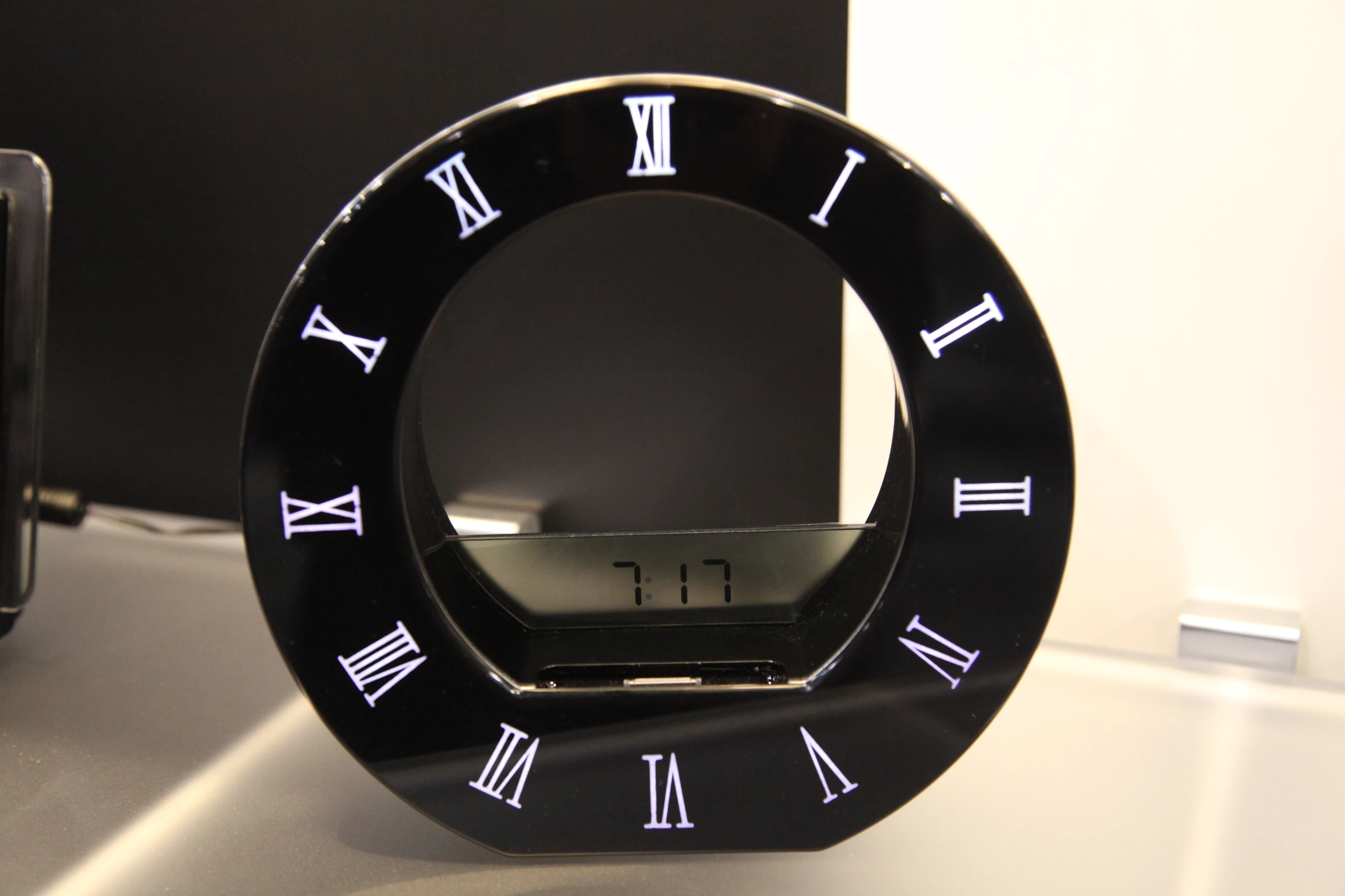 A digital LCD clock display activates when the iPod Touch or iPhone is undocked