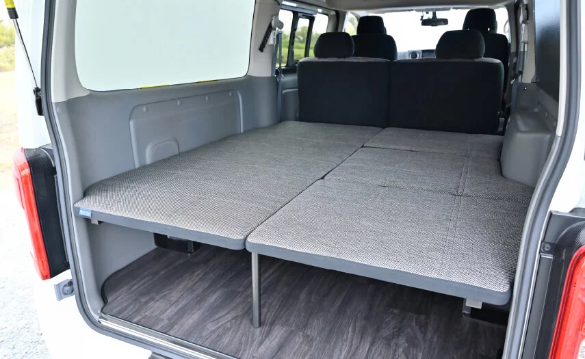 The three right-side cushions secure atop the side rail and center frame lip to complete the full-width bed