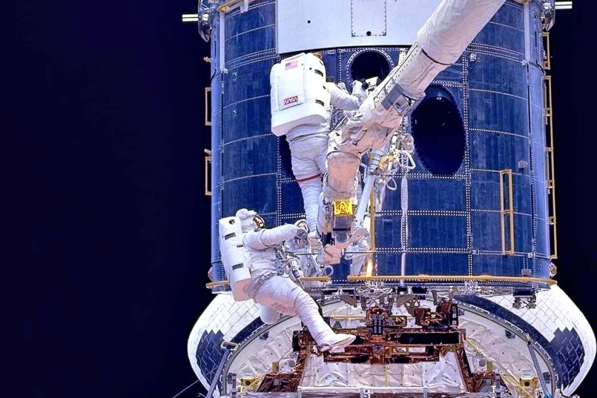 Astronauts fitting corrective optics to Hubble