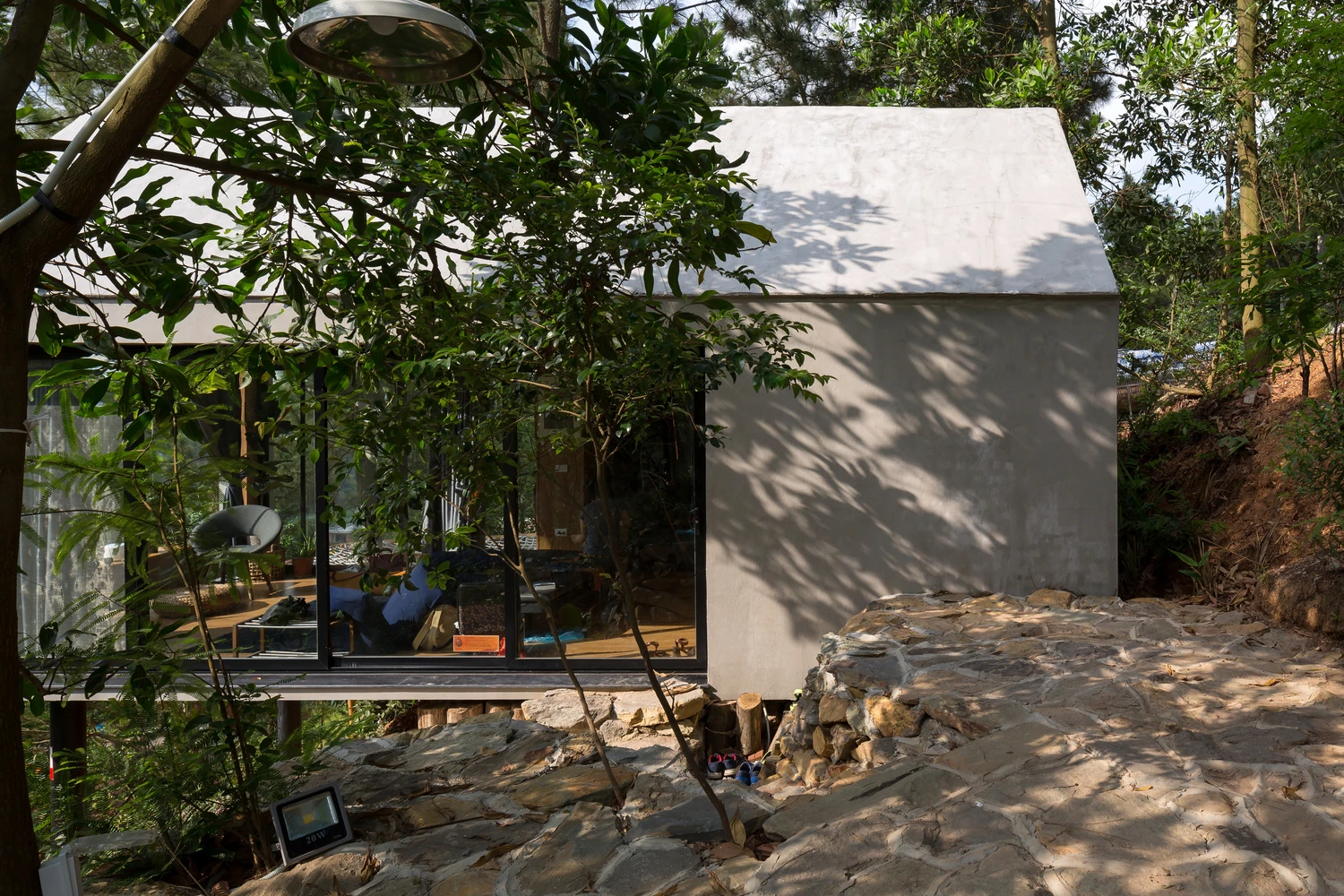 Side view of the tiny house from the lush landscape