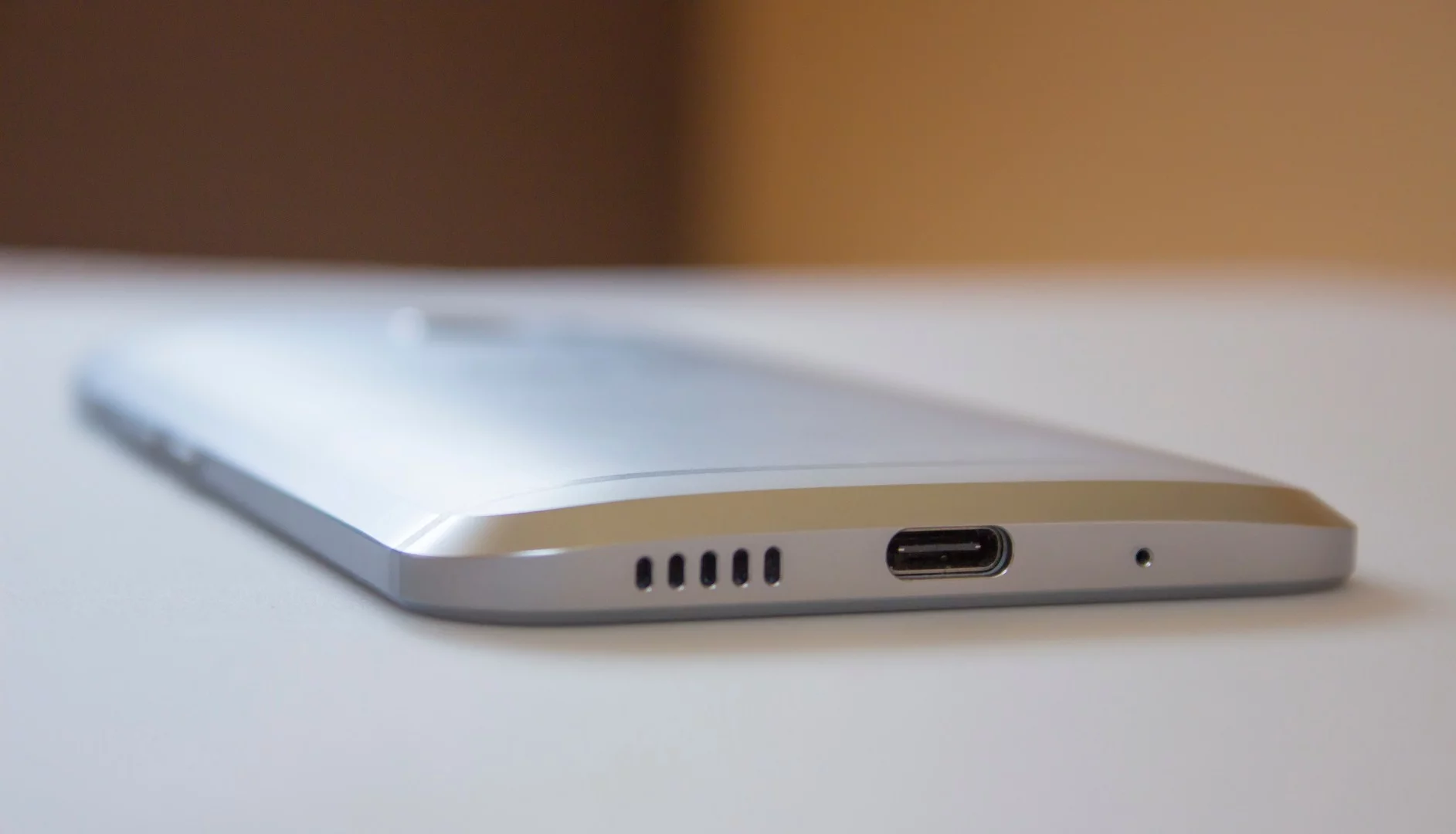 Its speakers move to the bottom edge (along with the ear speaker), with a USB-C port for charging