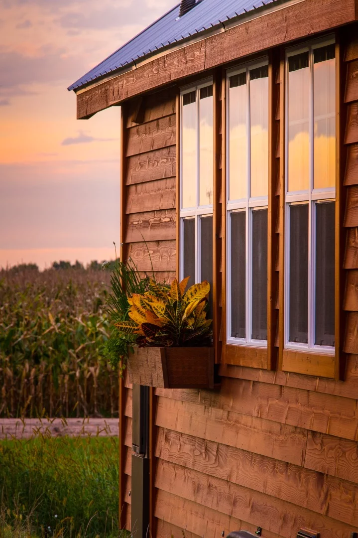 The tiny house sports cedar siding