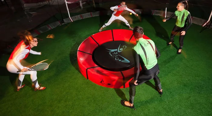 In the new racquet game of 360ball, players hit a ball into a central concave dish, trying to rebound it out of the reach of their opponents