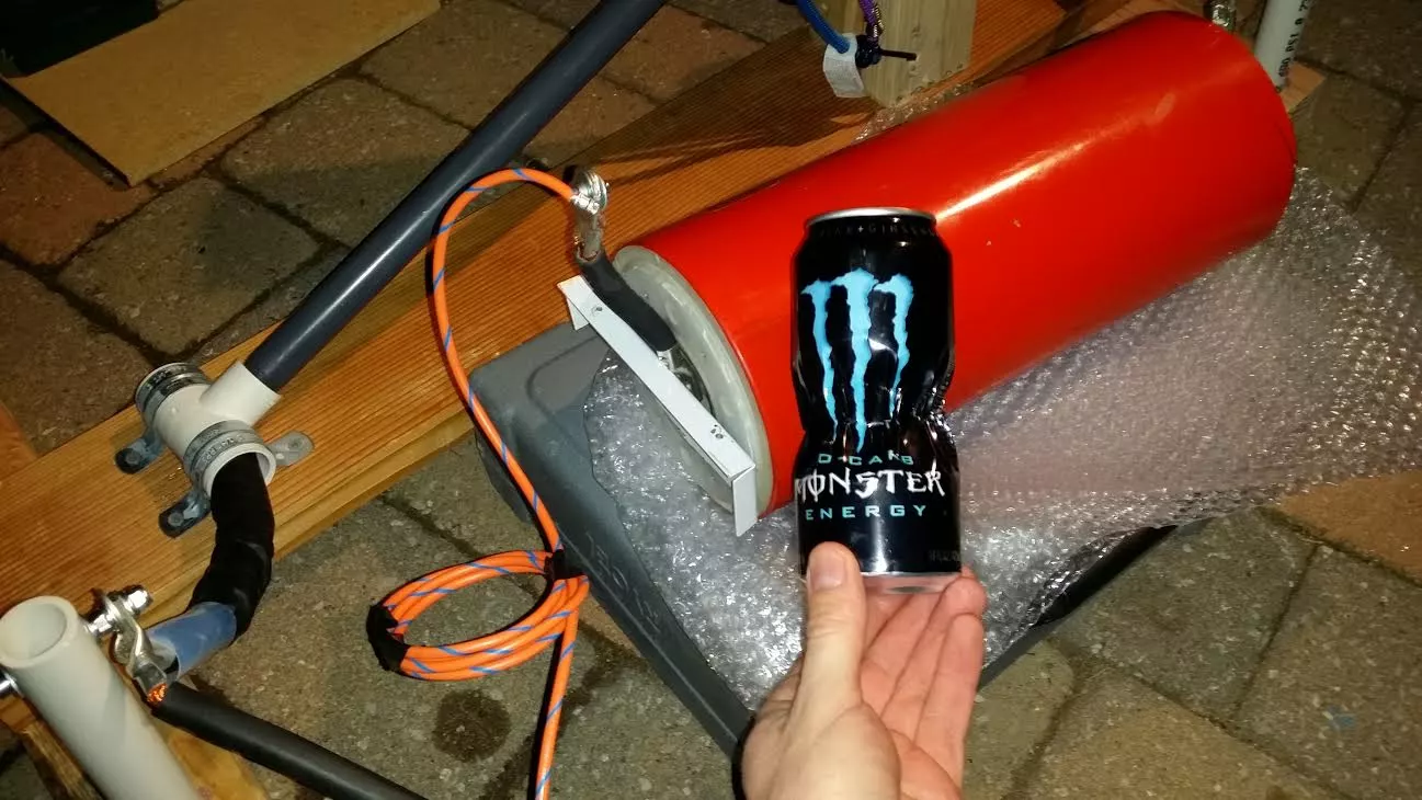 An aluminum can crushed by Luke's mini can crusher setup.
