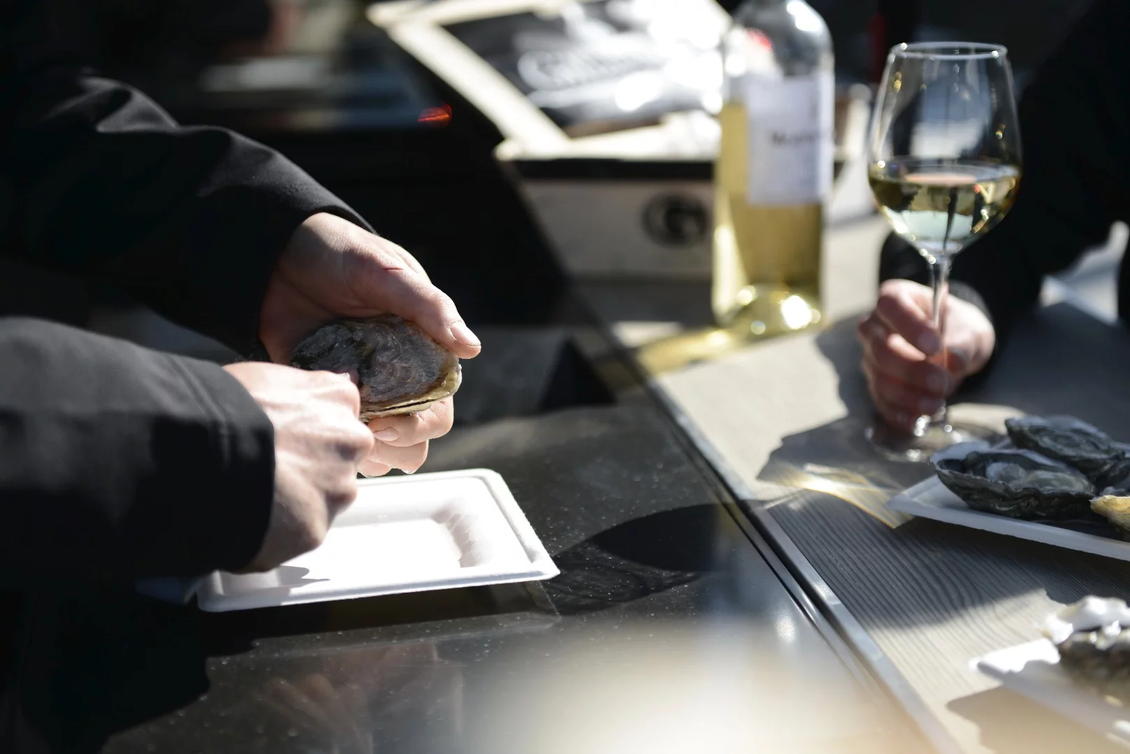 The shucker stands at the same level as the patron, instead of up in a truck