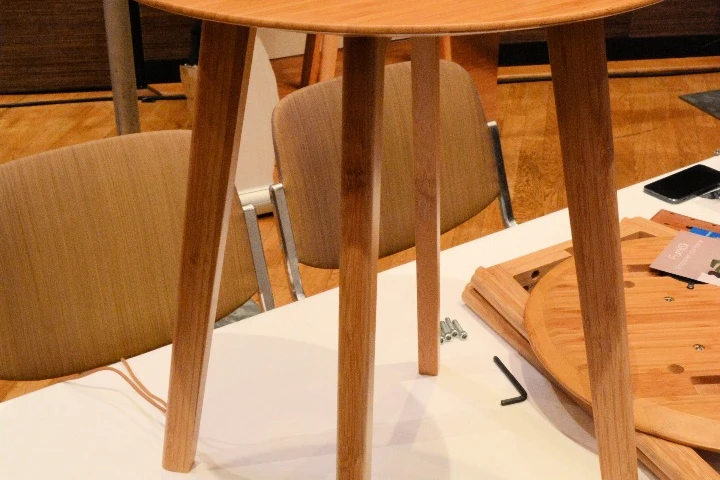 A fully-assembled FurniQi side table with Qi-compatible devices on top