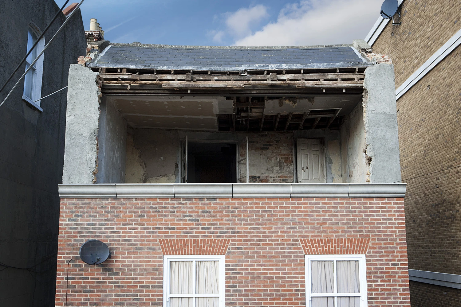 A gaping cavity exposes the innards of the top floor.(Photo: Alex Chinneck)