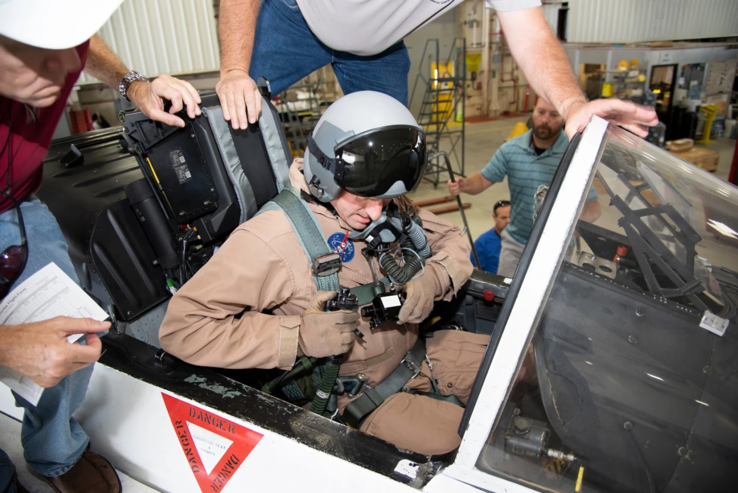 NASA pilot Jim Less sits in the cockpit of a NASA F/A-18 aircraft in preparation for flight tests that will be used to understand the physiological impacts that high-performance aircraft have on pilots