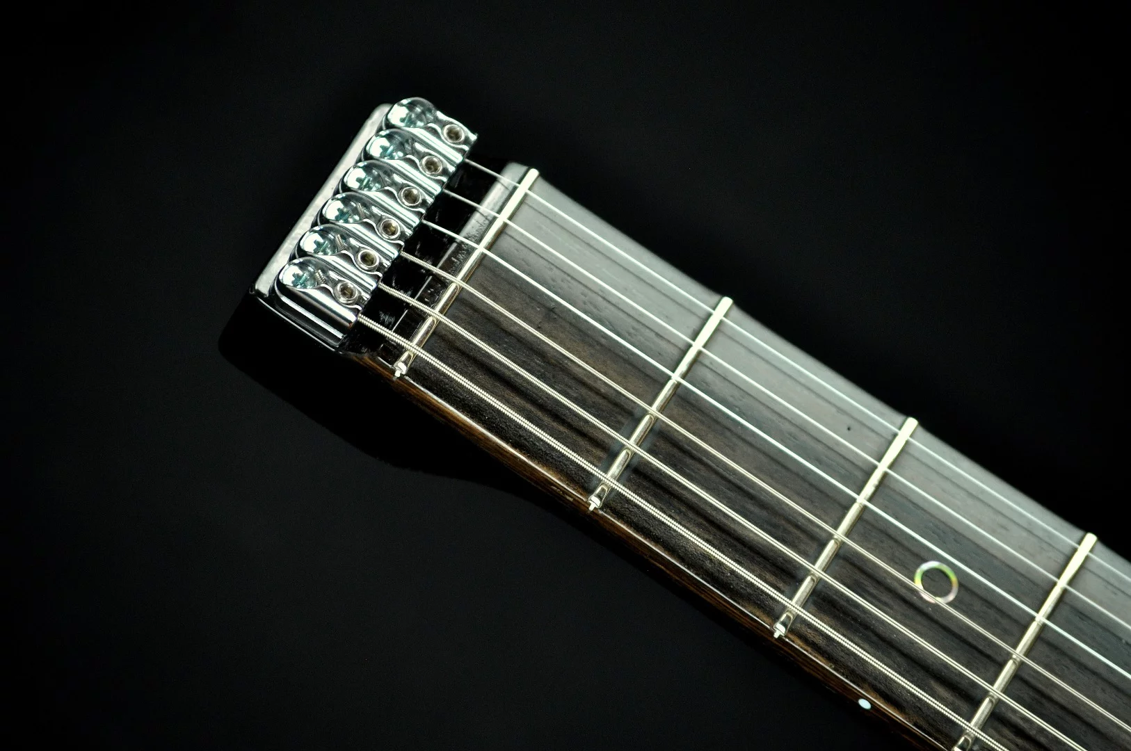 Chrome locking nuts top the Ego Thunder's headless neck
