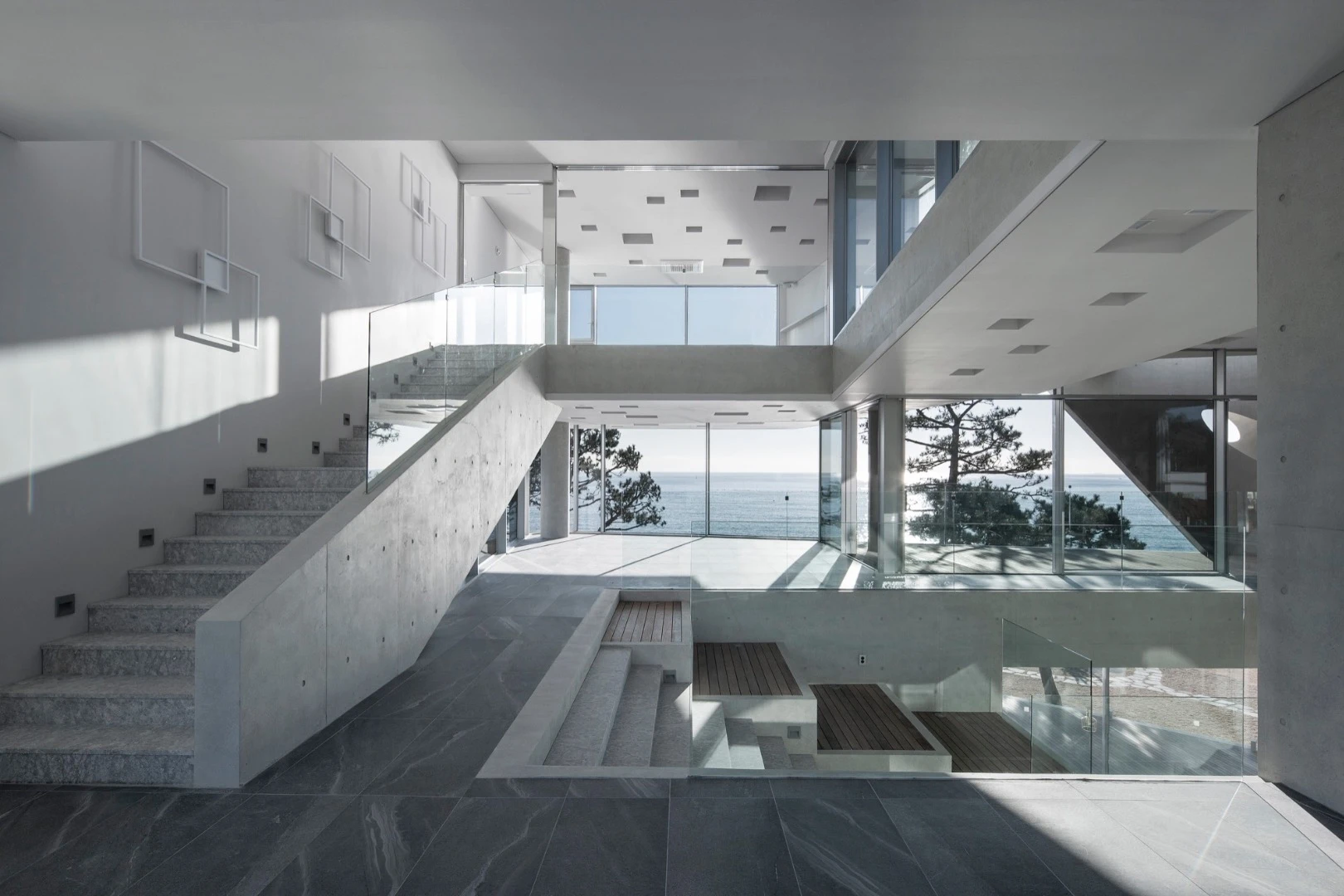 The Gijang Waveon cafe's interior features ample glazing, which frames the view at multiple angles