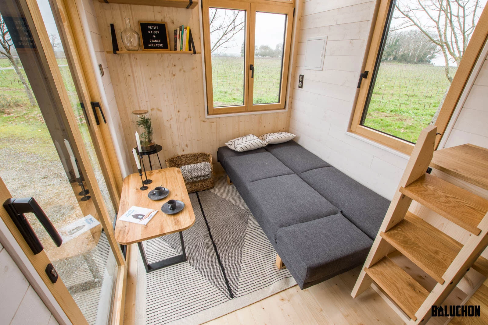 The Kejadenn's living room features a sofa bed, shown in the bed position