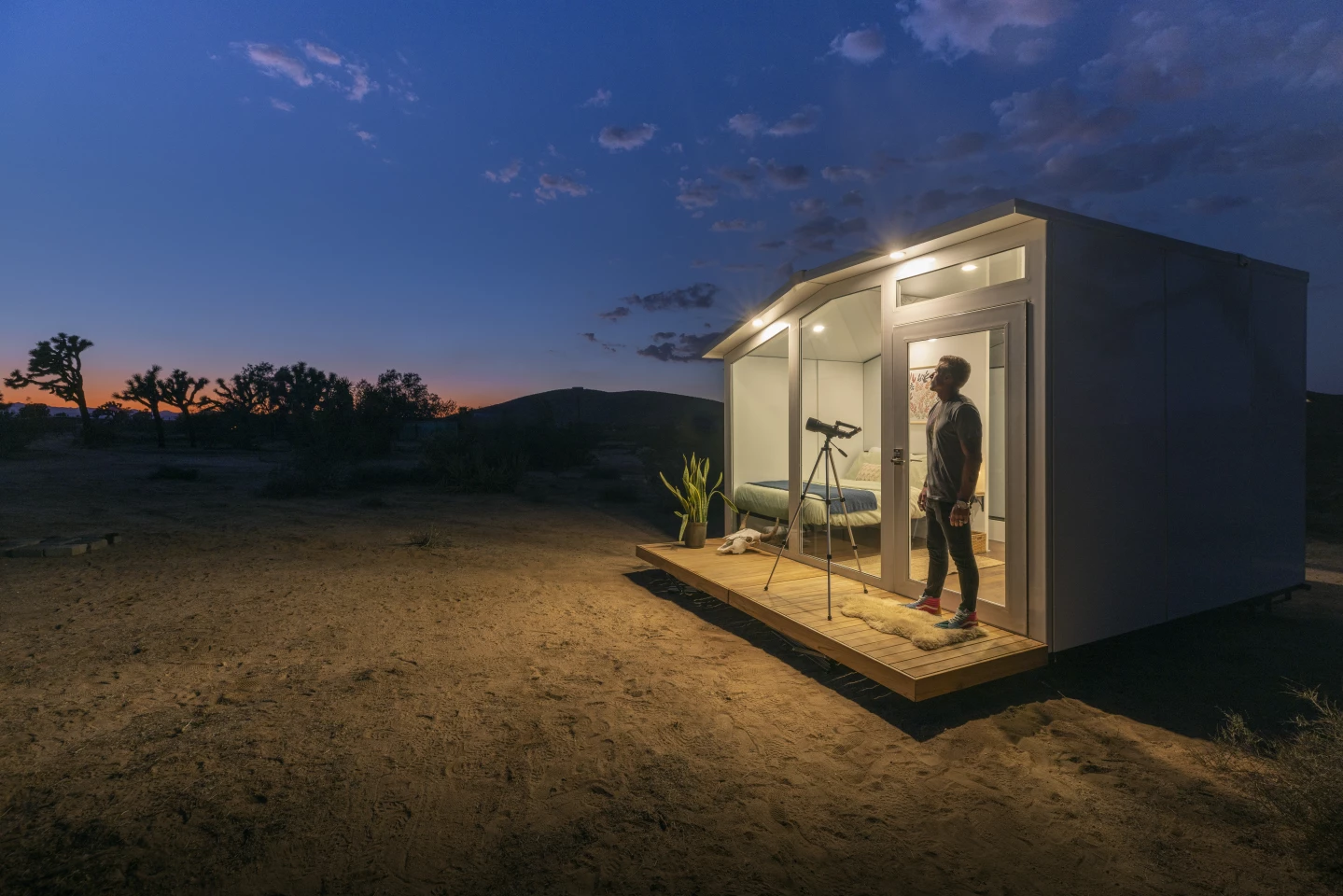 The tiny home boasts 8.5-ft (2.6-m)-high ceilings, a floor-to-ceiling feature glass wall, and a large outdoor terrace