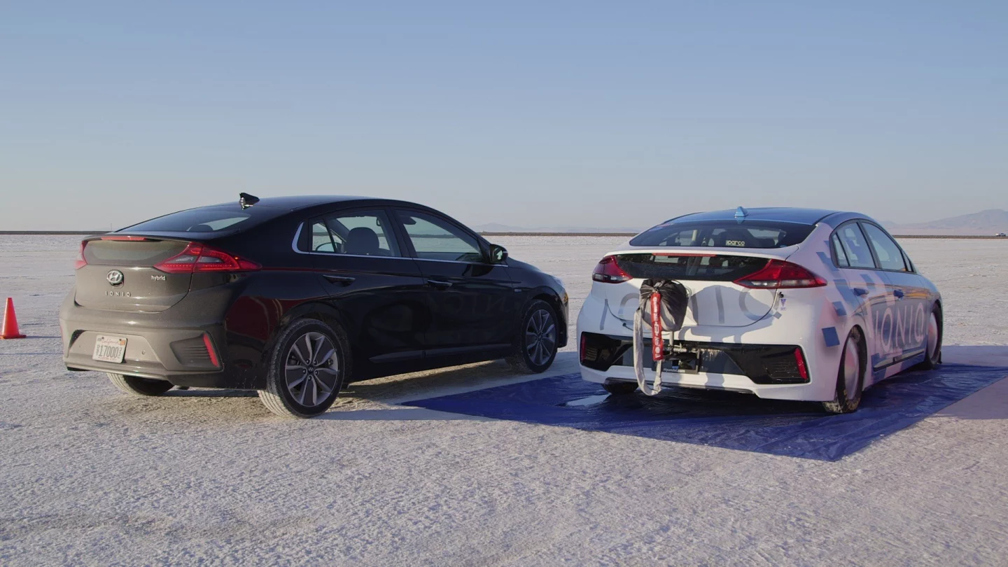 A stock Hyundai Ioniq Hybrid (left) sits next to the modified Bonneville record-holding Ioniq Hybrid