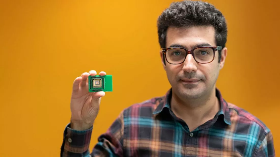 Khosro Zangeneh Kamali, PhD scholar at the Australian National University, with the team's electrically programmable silicon metasurfaces proof of concept