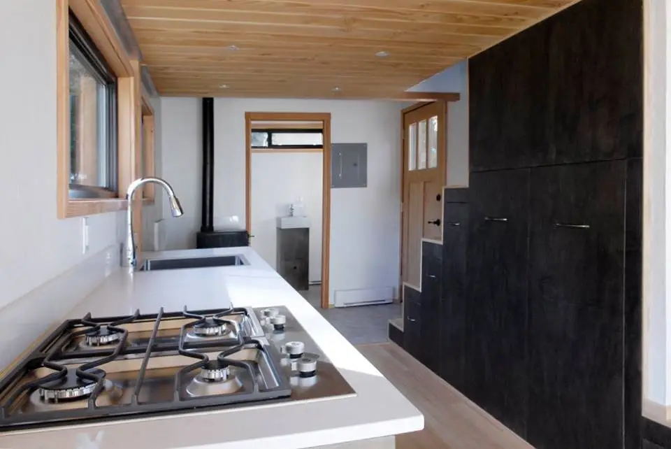 A kitchenette sports propane burners and on-demand hot water plus plenty of storage space (Credit: Jenn Walton)