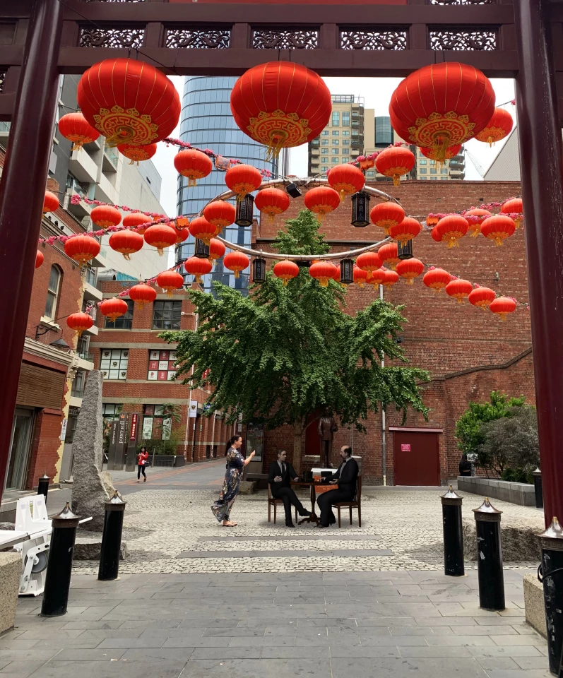 In a plaza in Melbourne's Chinatown, players will encounter a pair of doctors sharing a drink and discussing the case