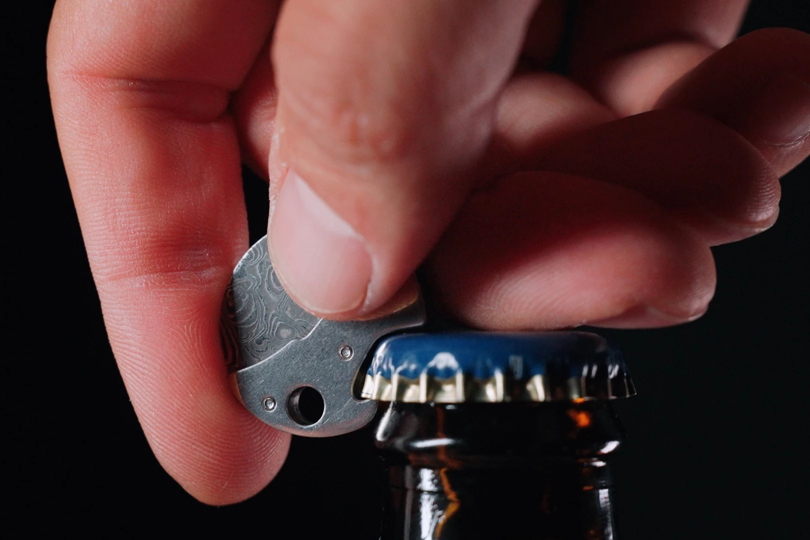 The Coin in bottle-opening action