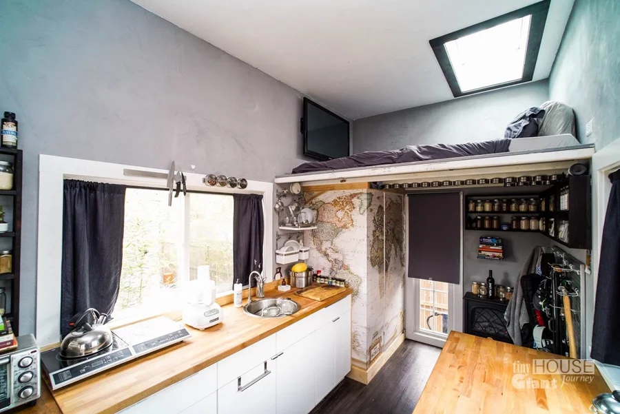 The kitchen workspace features magnetic storage solutions and small appliances (Photo: Tiny House Giant Journey)