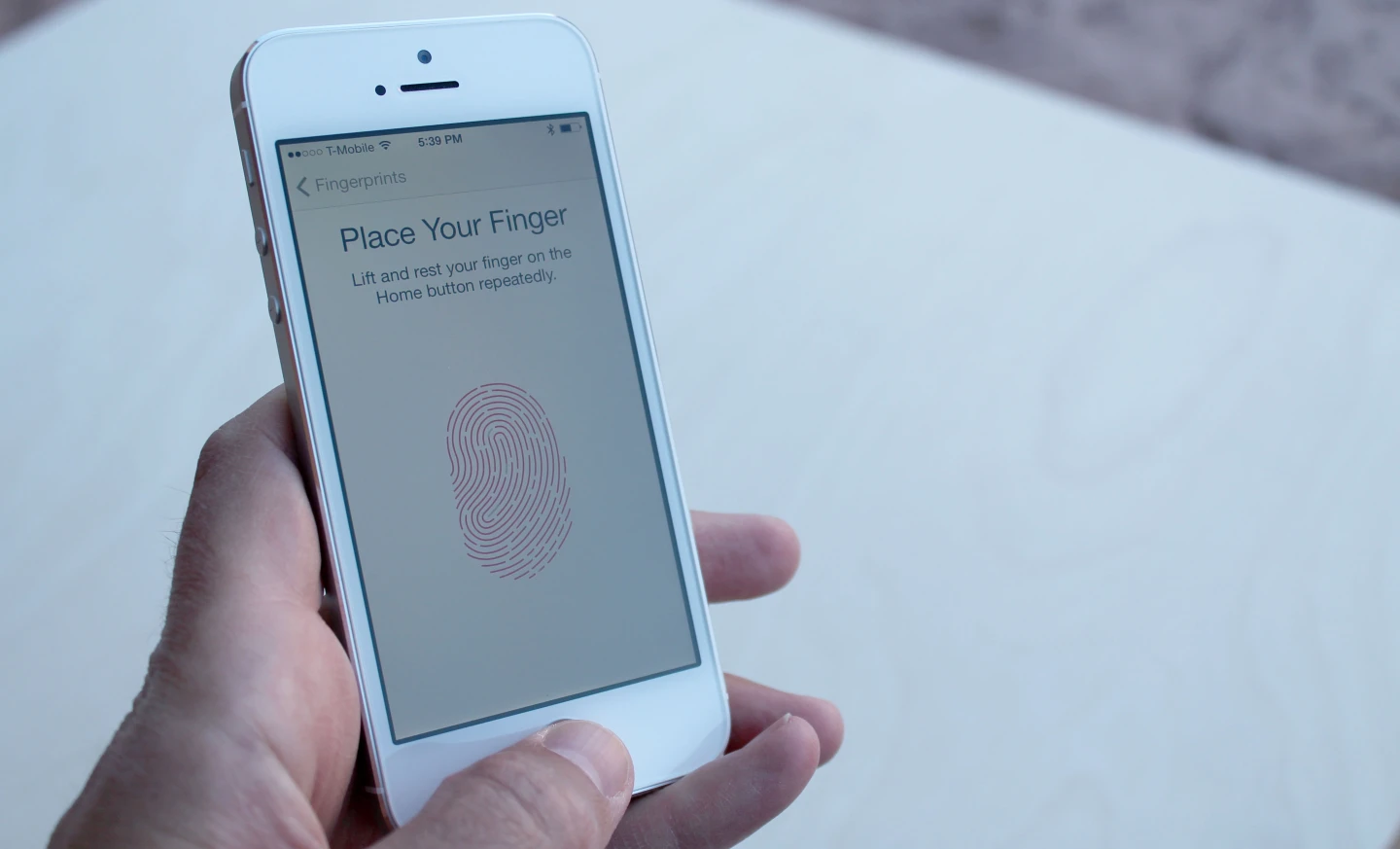 When setting up Touch ID, the 5s prompts you to hold your finger on the home button in brief segments