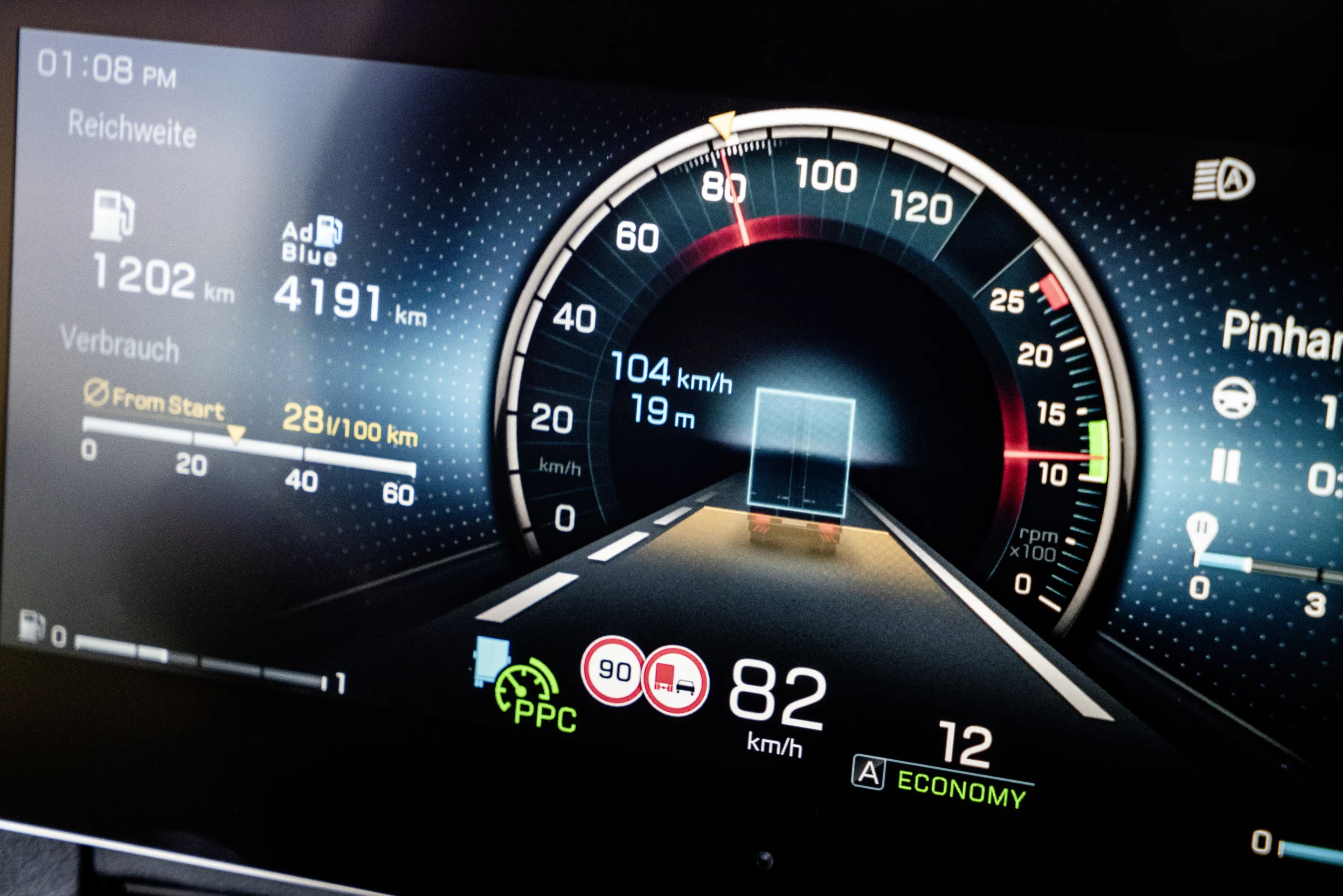 The driver's information screen in the instrument cluster of the Mercedes-Benz Actros truck shows safety and trip information as well as driver assist output