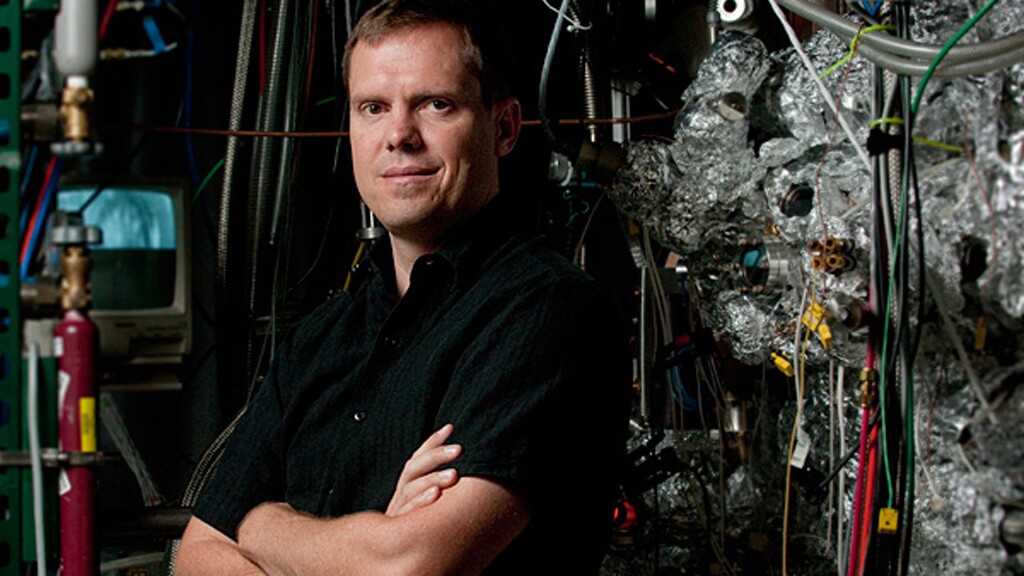 Nick Melosh, assistant professor of materials science and engineering, stands beside the ultra-high vacuum chamber used in the tests that proved the PETE process works (Image: L.A. Cicero)