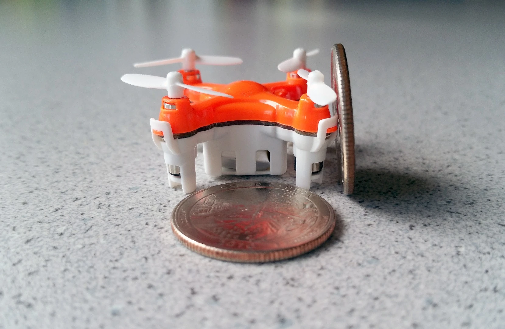 The Axis Drones Aerius quadcopter is shorter than a quarter's diameter, and could land on one too