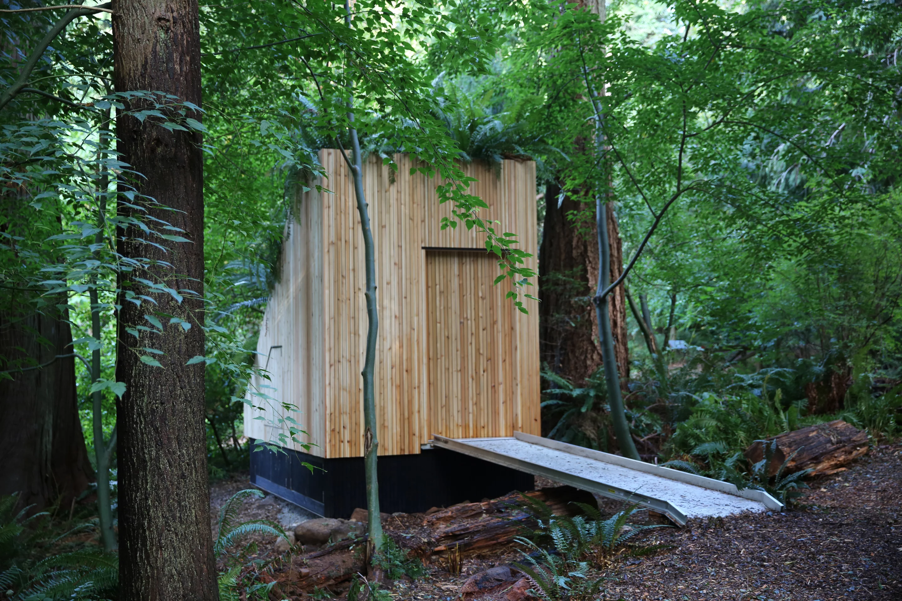 The MycoToilet has a sliding wooden door