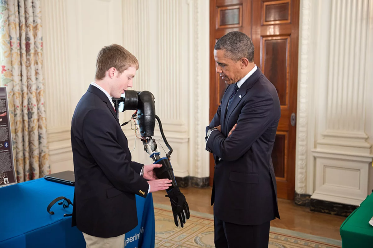 Easton LaChappelle demonstrates his prosthetic arm to President Barack Obama at the third annual White House Science Fair (Photo: The White House)