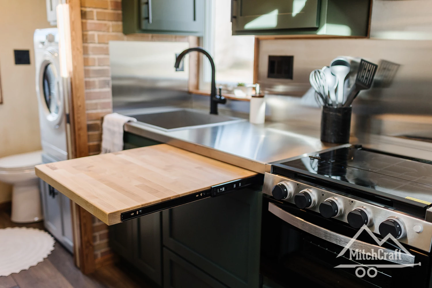 The kitchen in Nicole's 16 x 8 Tiny Home includes a handy pull-out table
