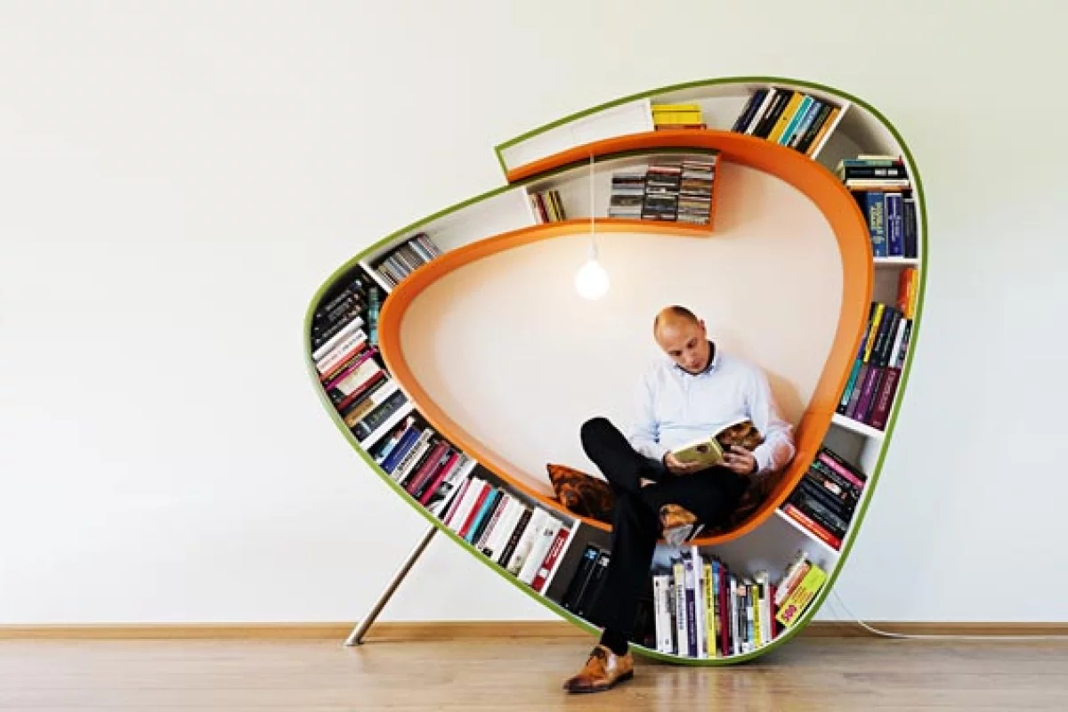 The Bookworm is a chair that surrounds the reader with their library, literally