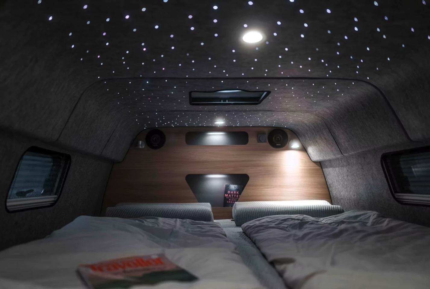 The primary Alphavan queen bedroom is a cozy space that becomes mesmerizing with the addition of the available starry sky headliner