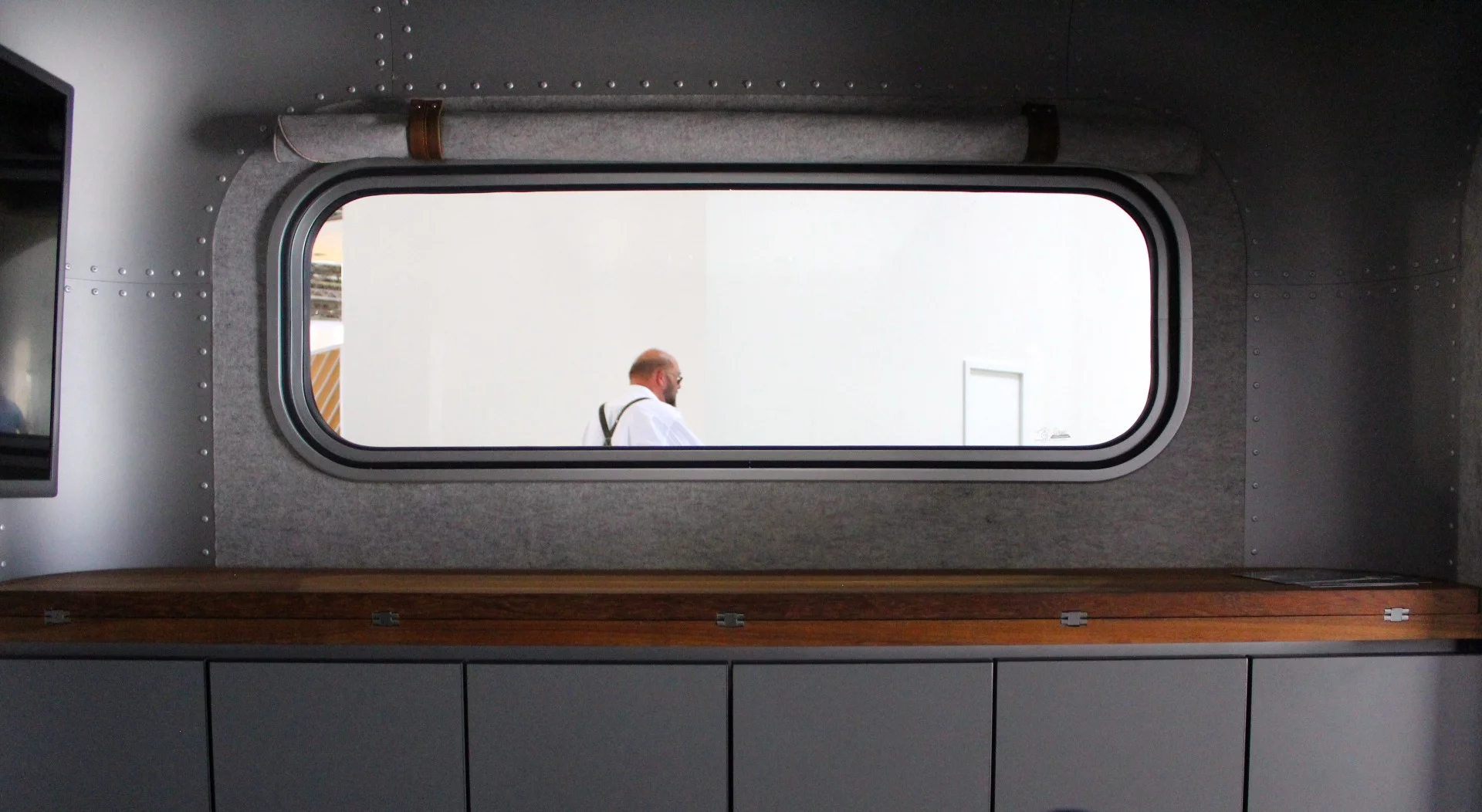 The Lume Traveler has a long window and cabinet area on its front wall