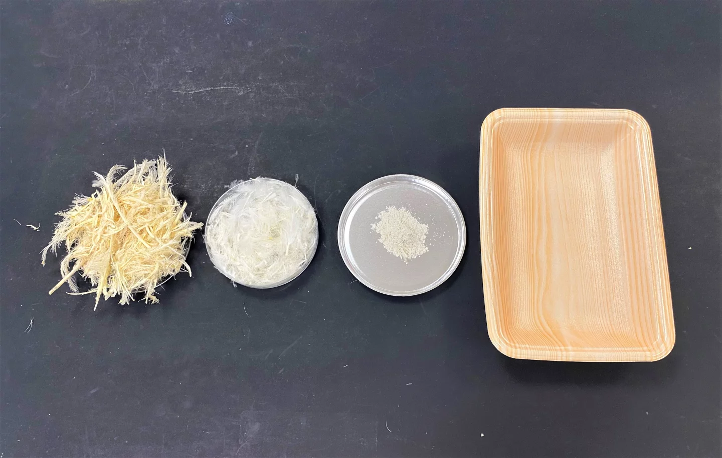 A step-by-step depiction of how chicken feathers are washed and ground into keratin powder, which is used in the production of meat trays