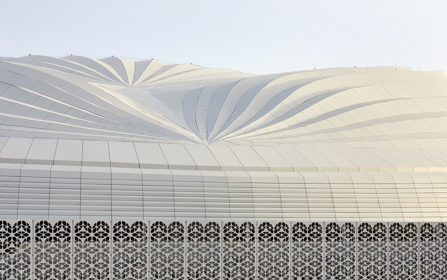 Al Wakrah Stadium's exterior features a bronze latticed screen inspired by traditional Islamic craftsmanship