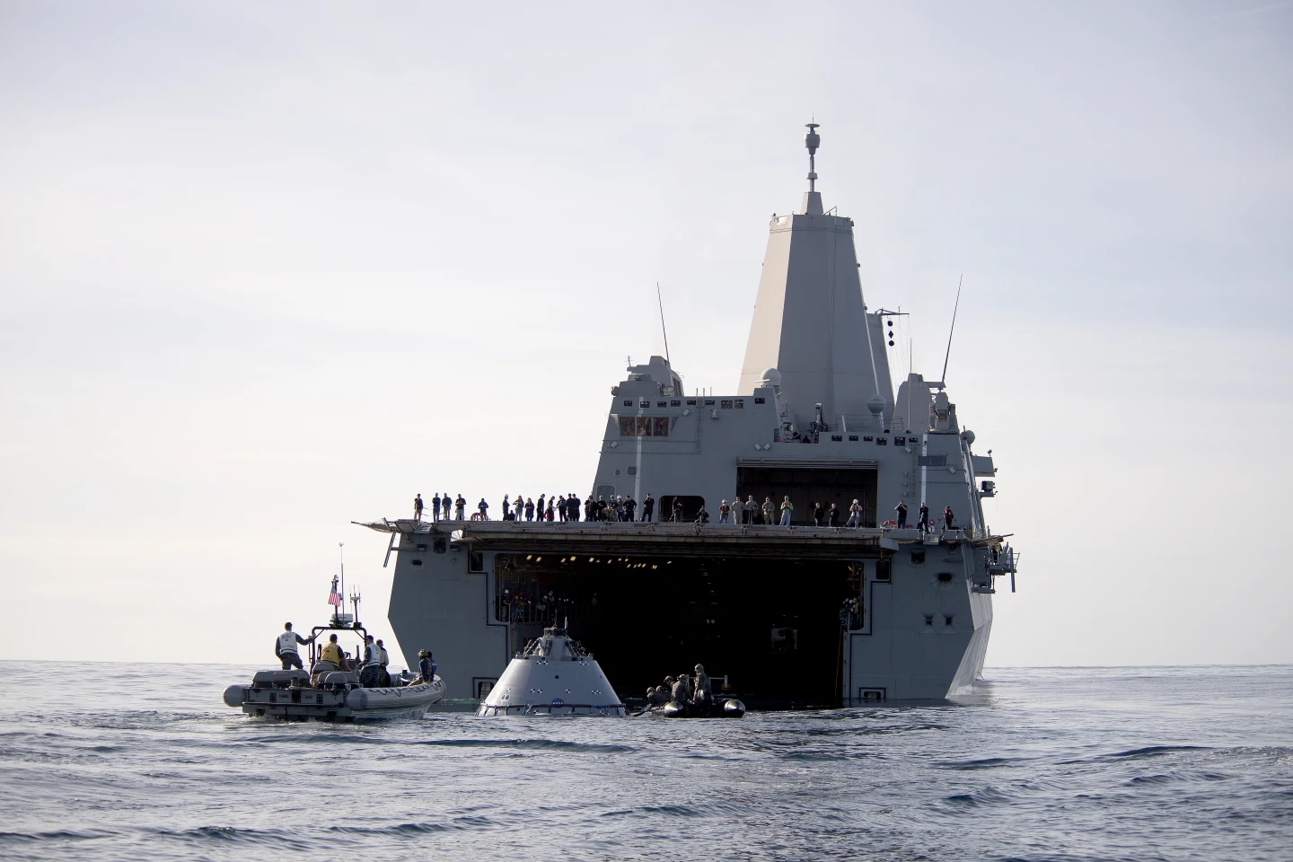 The Orion test capsule being guided into the well of USS Anchorage
