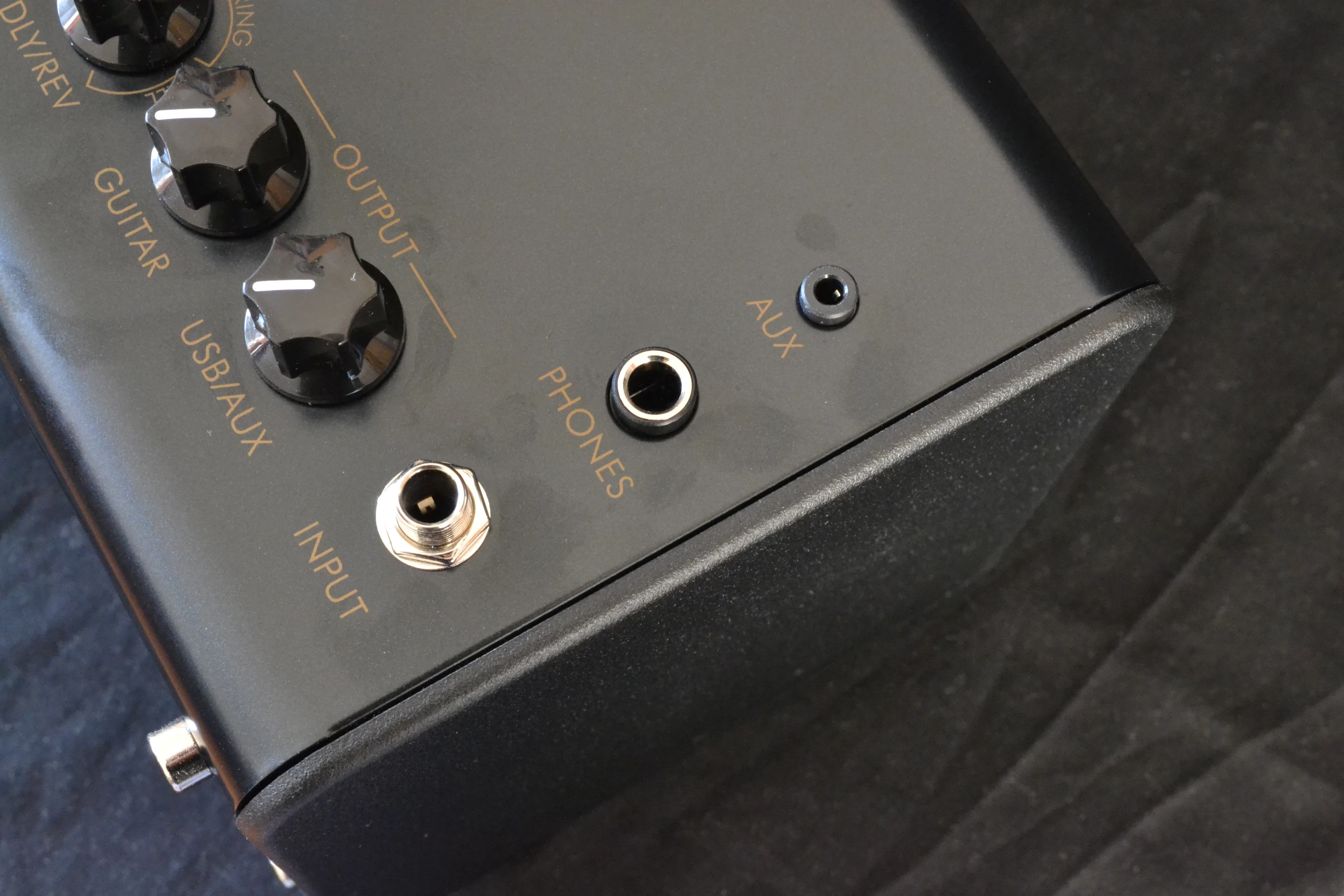 At the far right is a 0.25-inch instrument input, a 0.25-inch stereo headphone out jack and a 3.5-mm auxiliary input