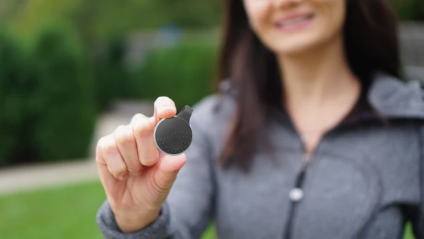 The small circular magnetic clip is equipped with Bluetooth and an activation button