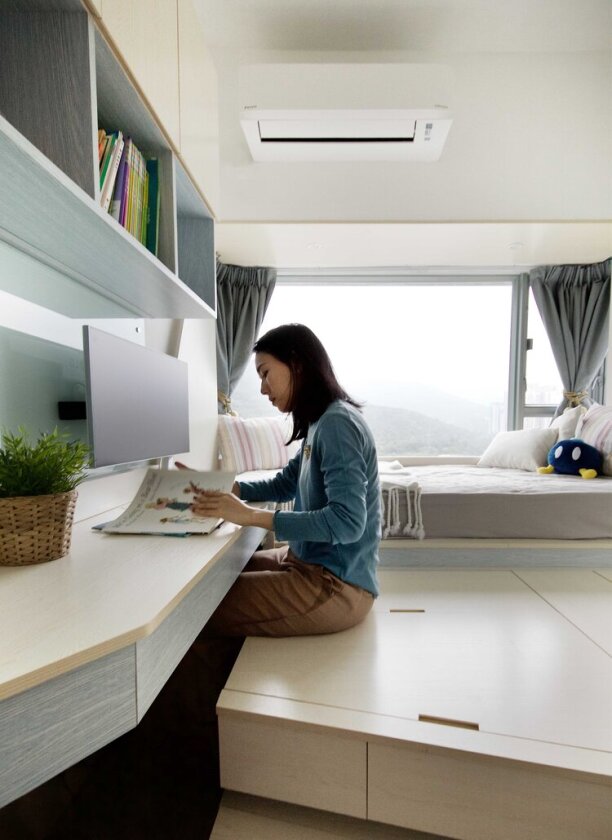 The second single bedroom with built-in study desk and wooden platform for additional storage