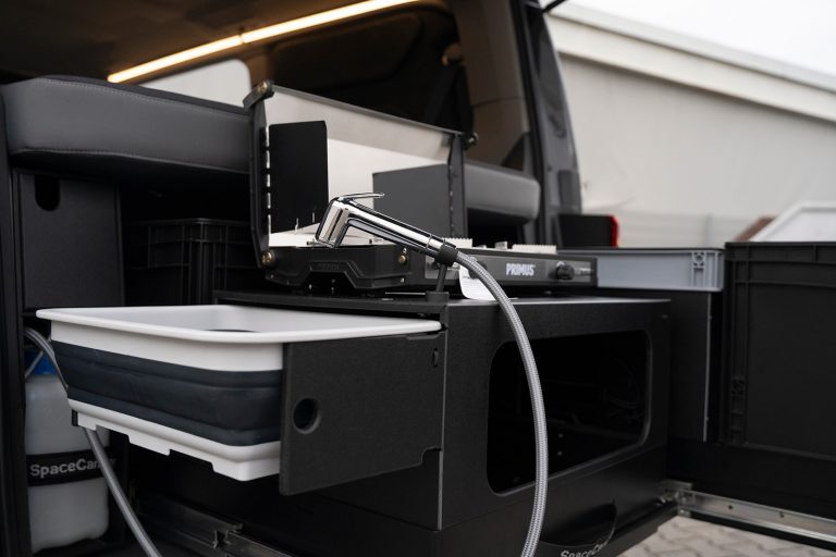 The Modular Serial 7 family available kitchen is a lightweight, minimalist design with a portable Primus stove, bucket sink and sprayer.