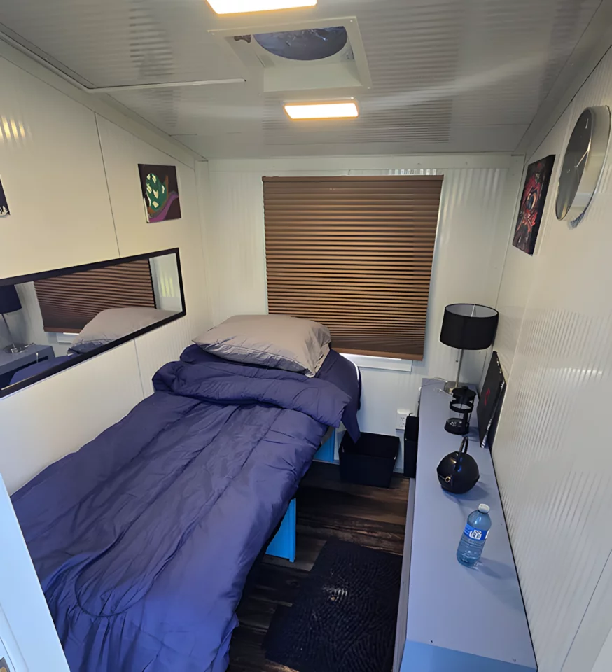 A bed/daybed is installed, and has some storage space underneath