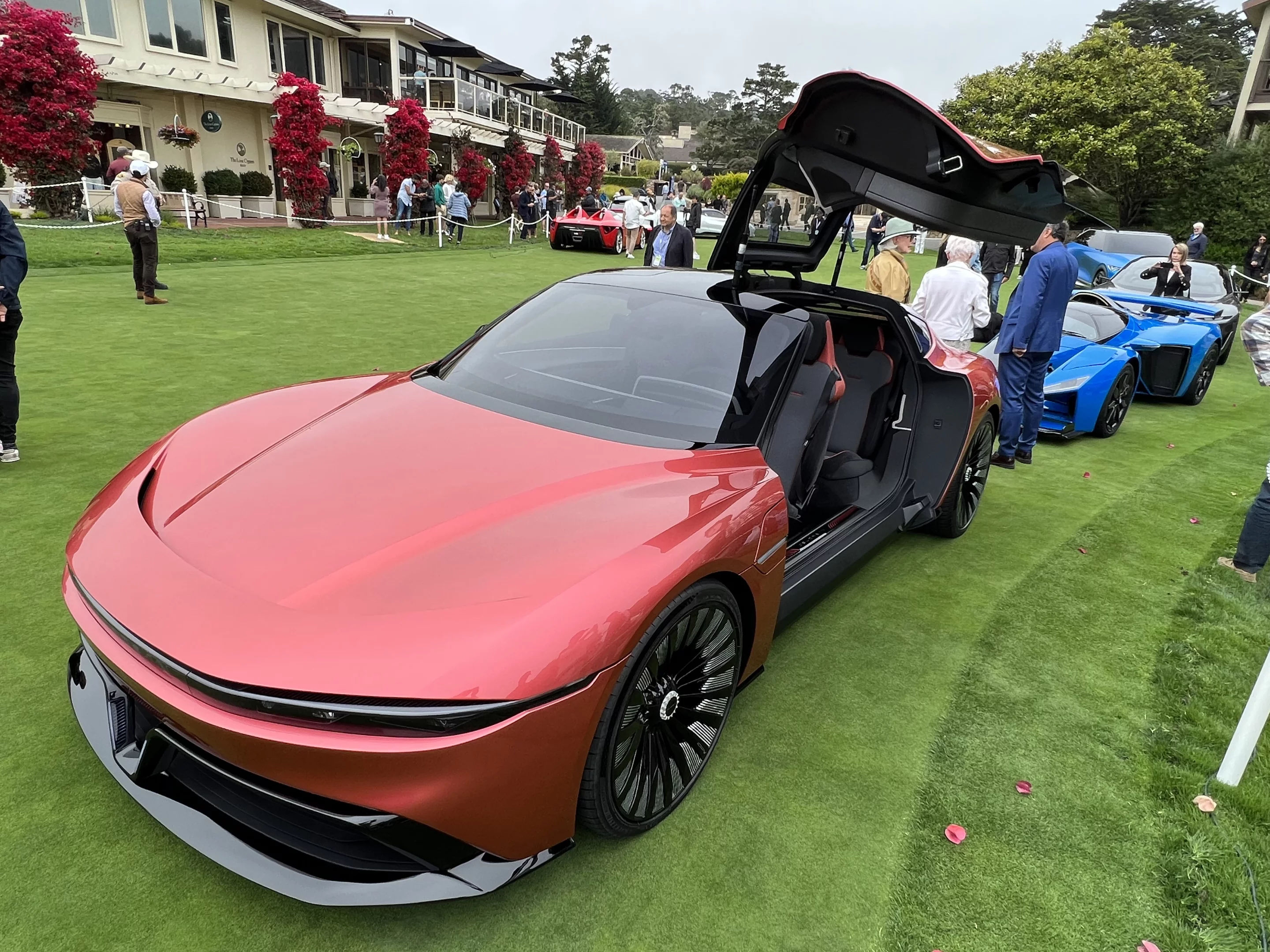The Alpha5 production model, with its gullwing door open, at Pebble Beach