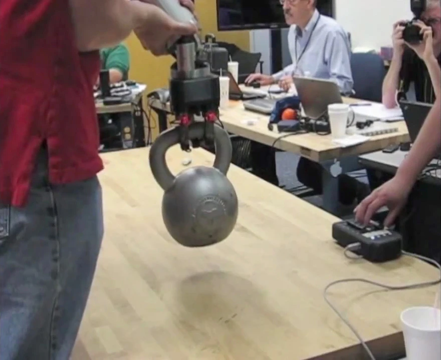 DARPA's ARM program hand can lift 50 pounds / 22 kg (assisted by a human, since the actual robot is incomplete)