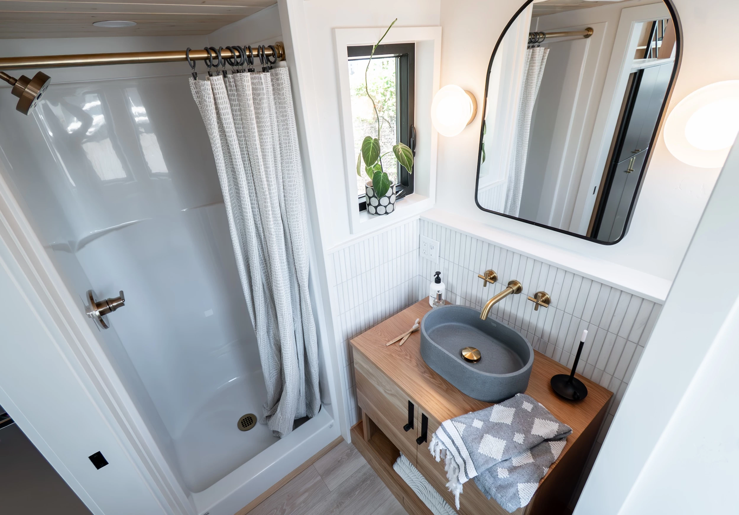 The Terra Urban's bathroom includes a stone sink, shower, and a flushing toilet