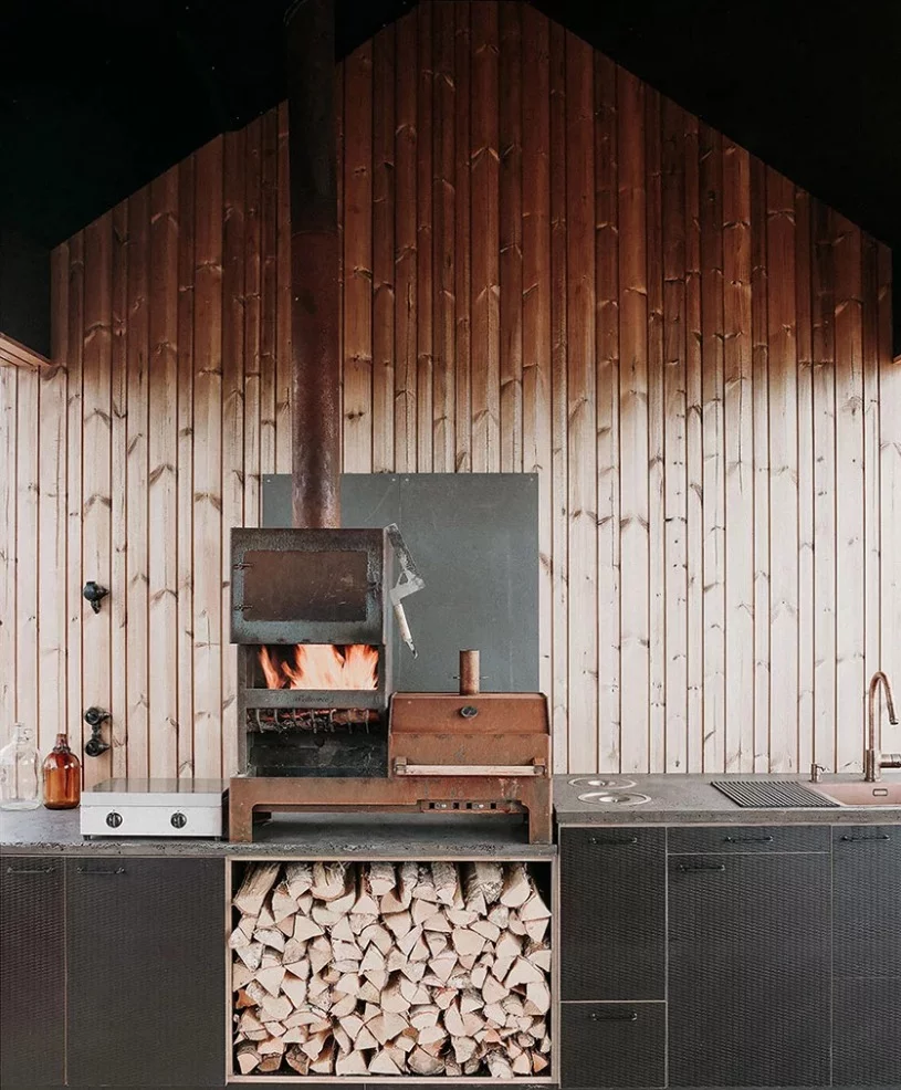 Additional exterior living space equipped with outdoor kitchen and dining area