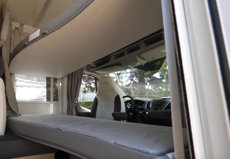 A curtain closes off the bunk/driver cab area for a little privacy