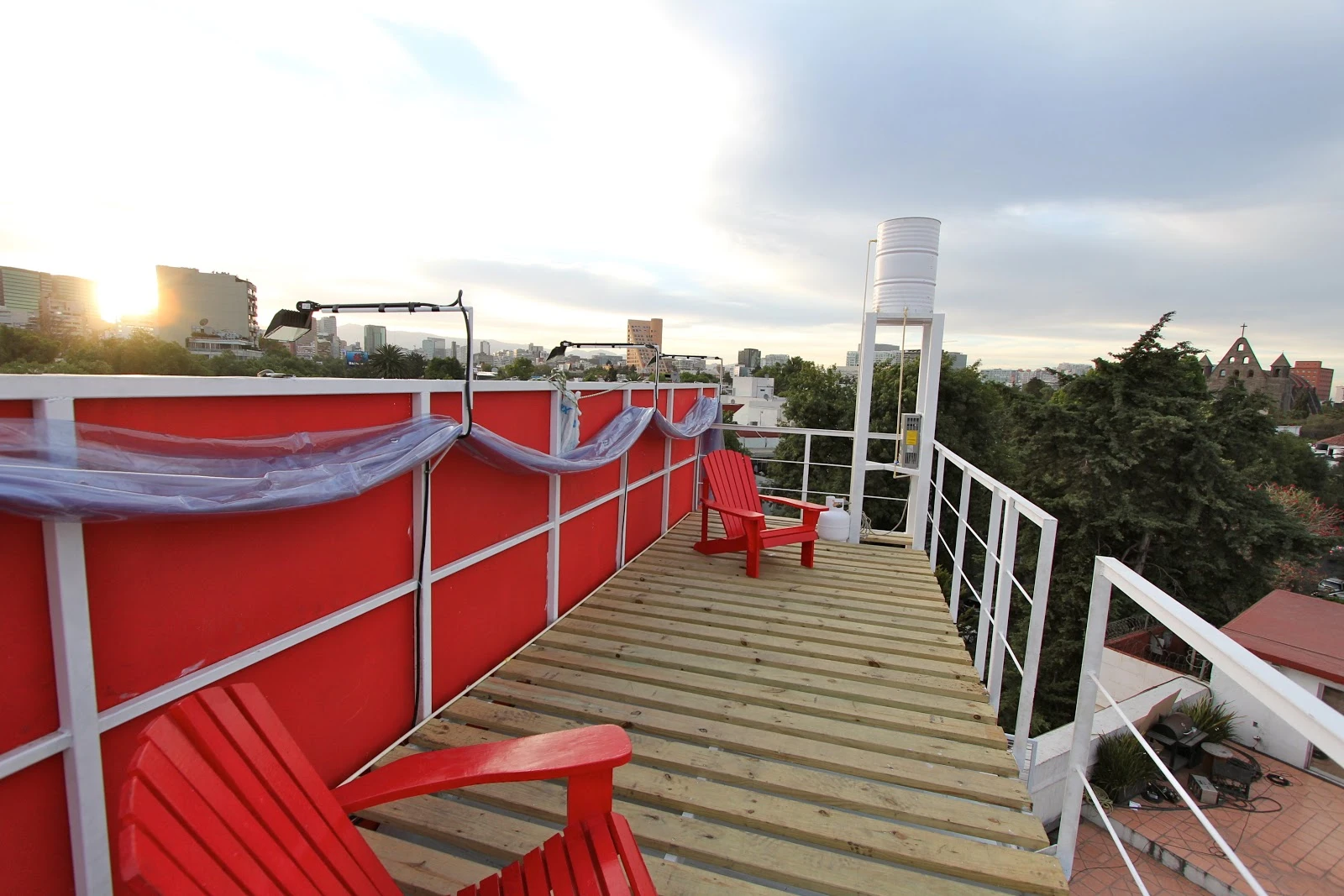 The roof has a wooden terrace that's separate from the main building, which both shadows the house from excess heat and gives residents an outdoor area for relaxing