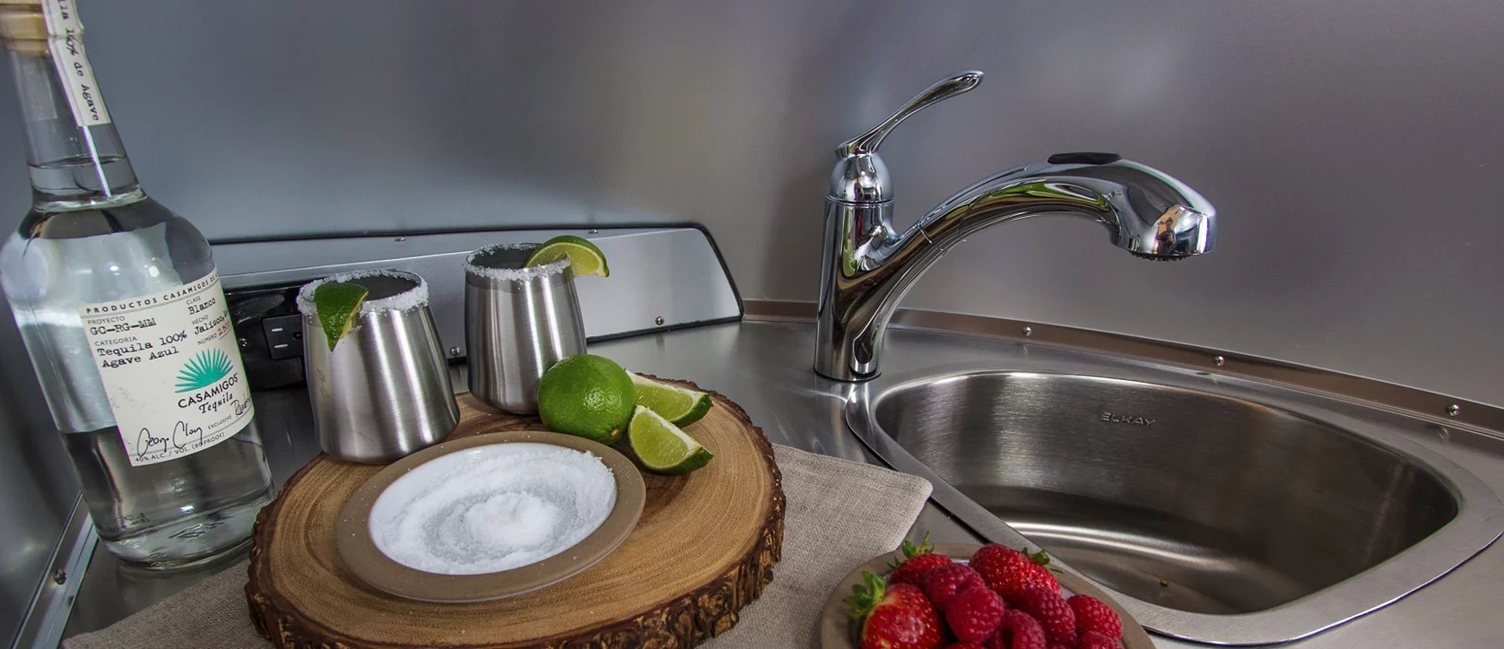 One side of the kitchen has the sink and microwave, and the other has the fridge and cooktop