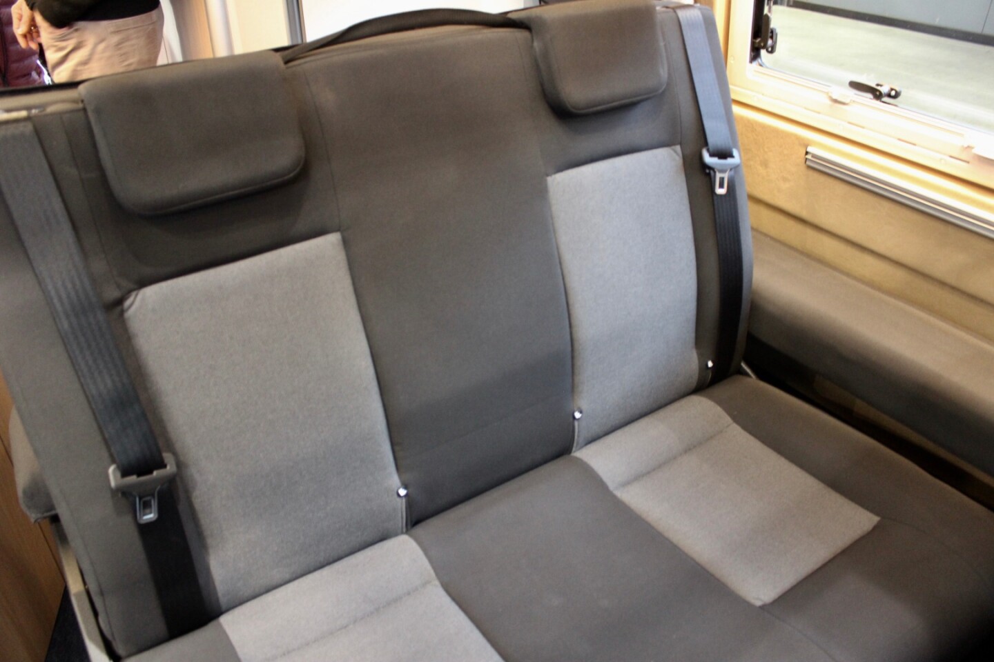 The bench works as a passenger seat, lounge and dining area before turning into the bed at night