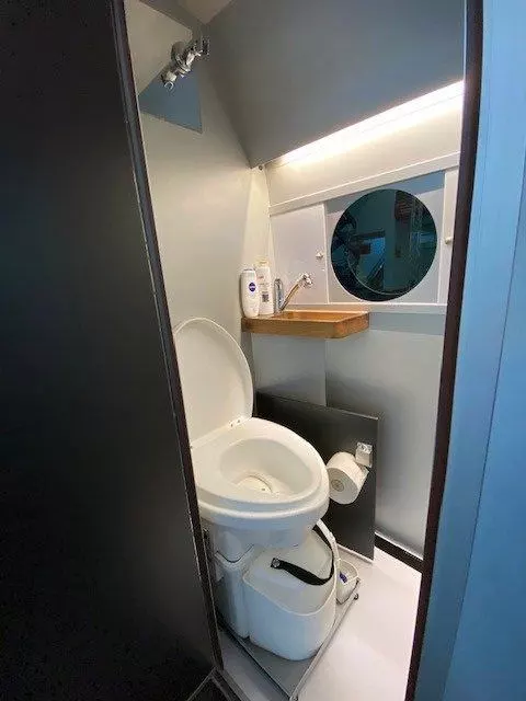 The updated bathroom has a nicer sink, slide-out toilet and finished window design
