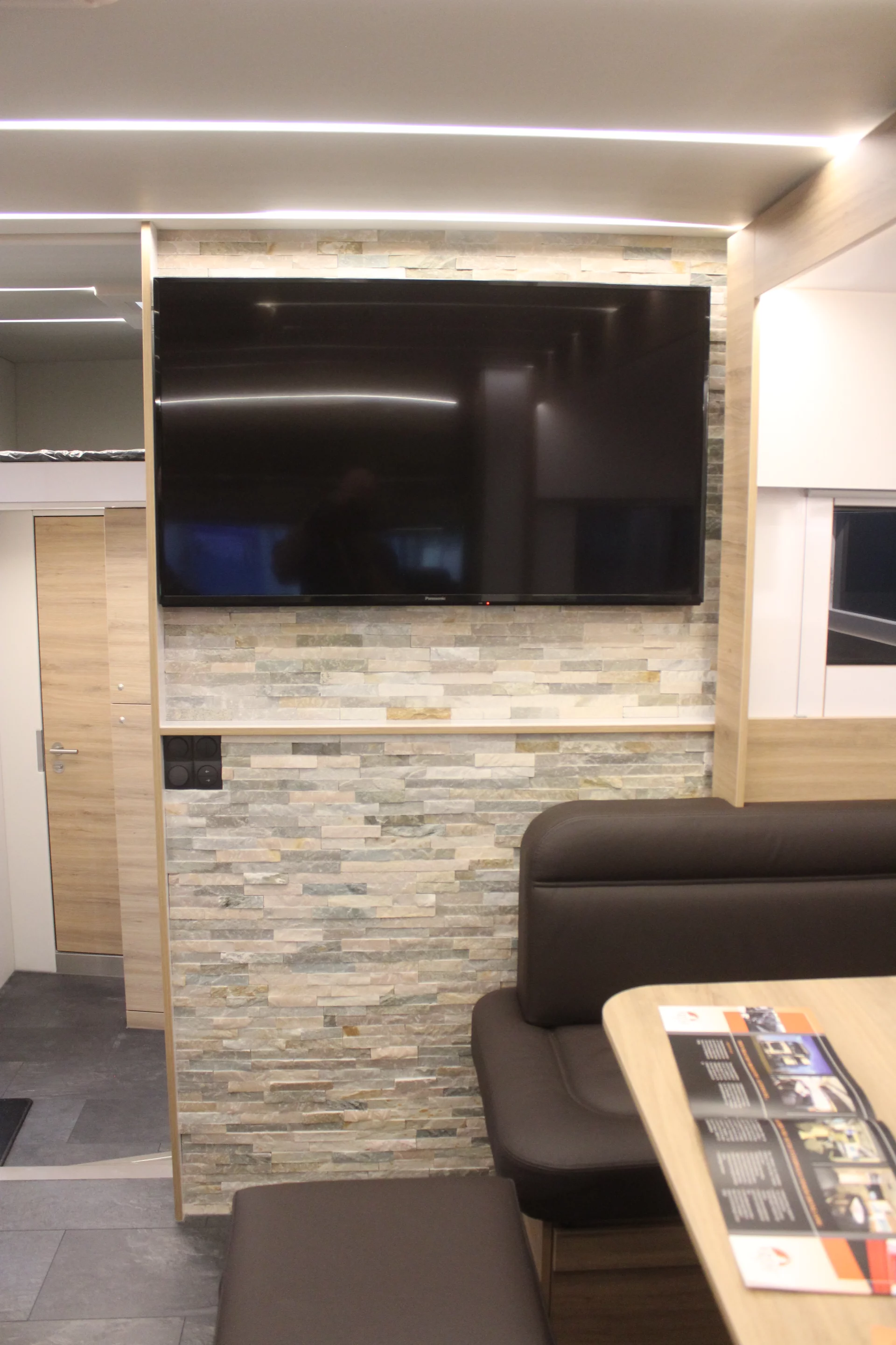 The entertainment system includes a flat-screen TV in the living area